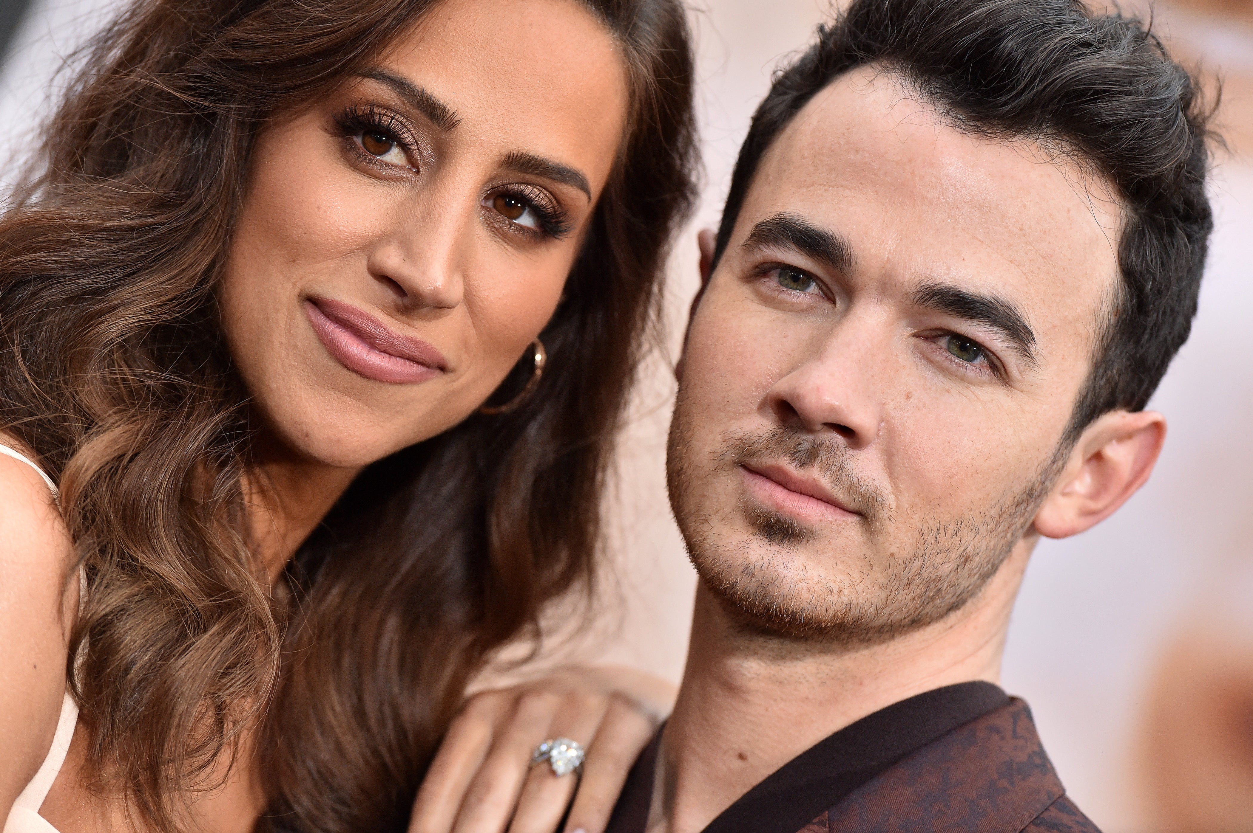 Kevin Jonas and wife Danielle can't keep their hands off each