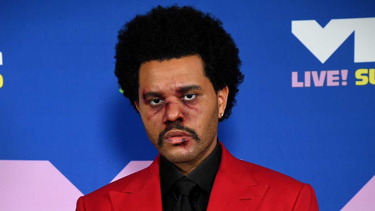 The Weeknd sports bloody makeup and bandaged nose on his way to