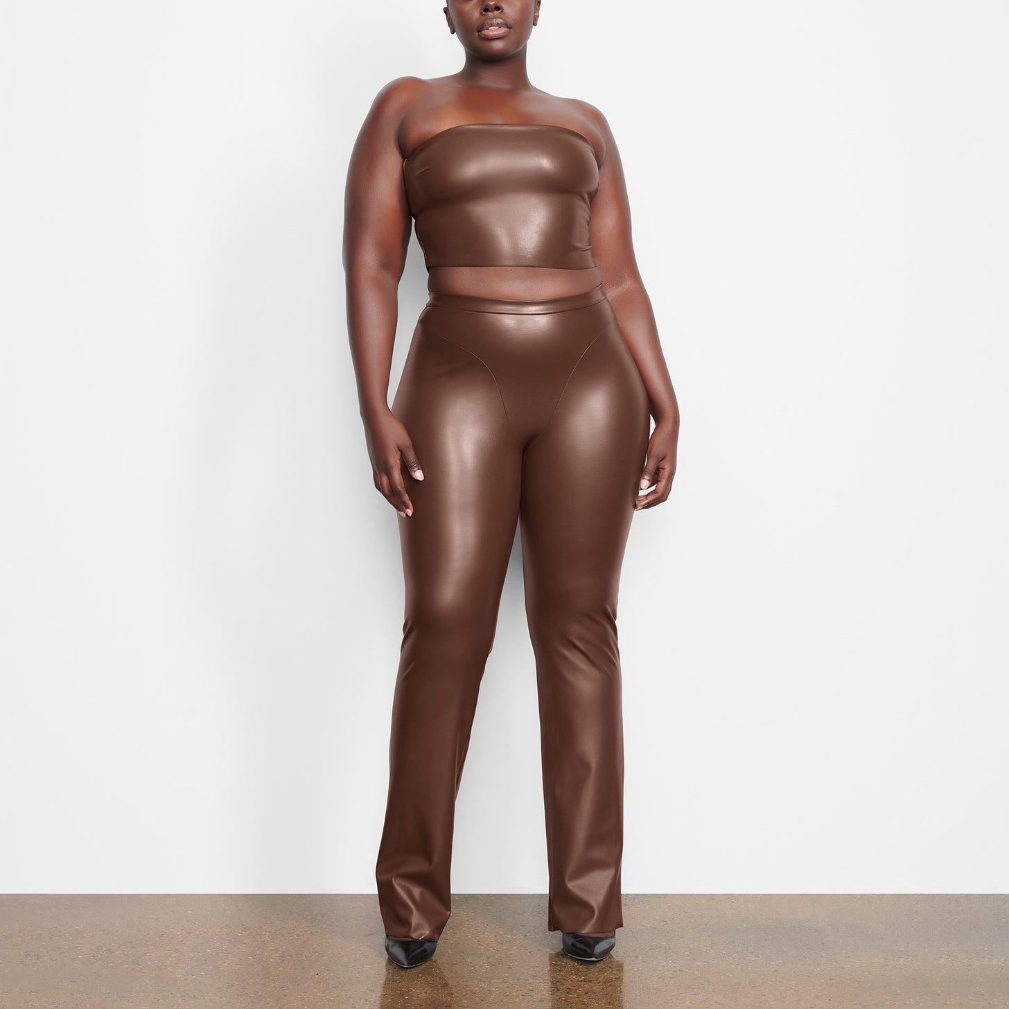 Kim Kardashian Models Rubber and Faux Leather Swimwear for SKIMS