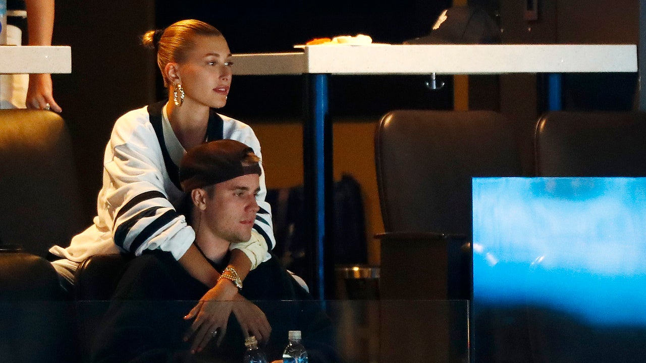 Justin Bieber watches alongside his wife Hailey Baldwin, right, during NHL  hockey action between the Philadelphia Flyers and the Toronto Maple Leafs,  in Toronto on Saturday, Nov. 24, 2018. Justin Bieber is