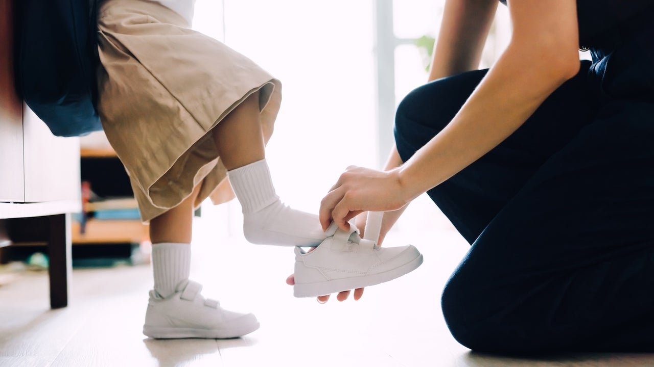 mom putting son's shoes on