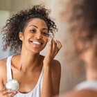 Woman applying moisturizer