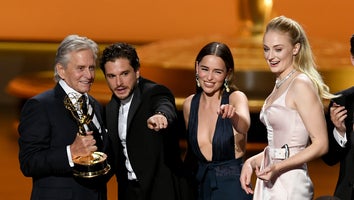 Game of Thrones cast members Kit Harrington, Emilia Clarke and Sophie Turner accept an award from Michael Douglas at the 2019 Emmys.