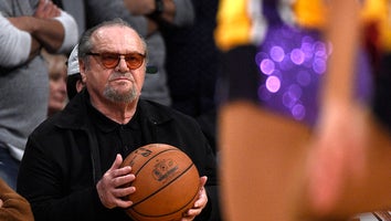 Jack Nicholson holds the game ball as he attends a basketball game between the Golden State Warriors and Los Angeles Lakers before Laker legend Kobe Bryant's jersey was retired at Staples Center on December 18, 2017 in Los Angeles, California.