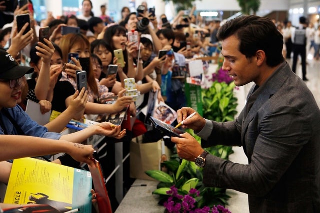 Henry Cavill signs autographs for fans at the Incheon Airport in South Korea on July 15.