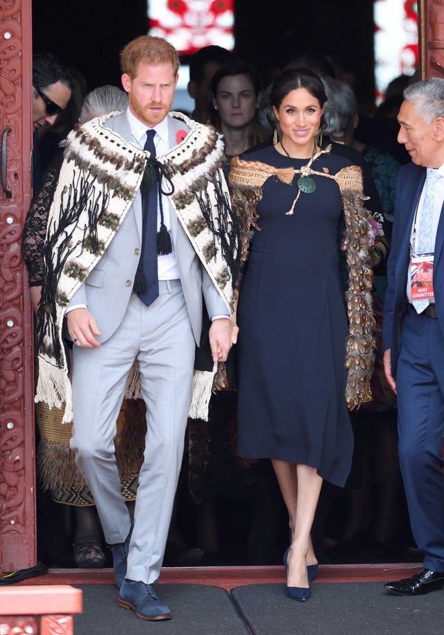 Prince Harry and Meghan Markle don Maori cloaks while visiting New Zealand on Oct. 30