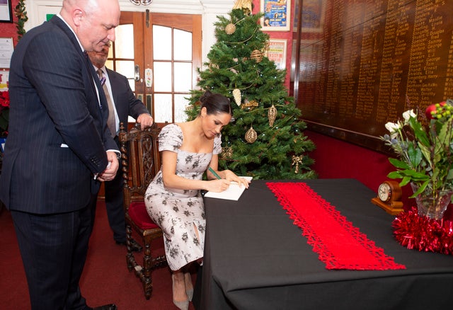 Meghan Markle signs card at Brinsworth House