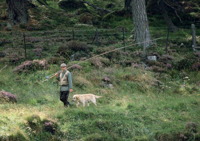Prince Charles and his dog harvey go fishing in 1982