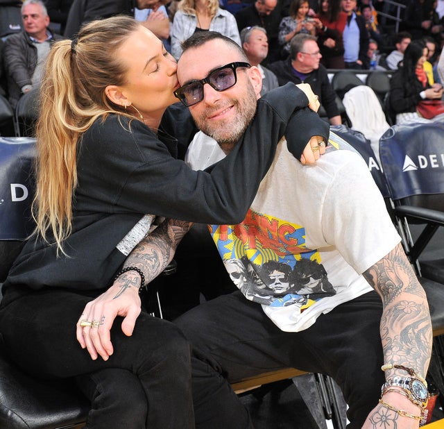 Behati Prinsloo and Adam Levine at basketball game