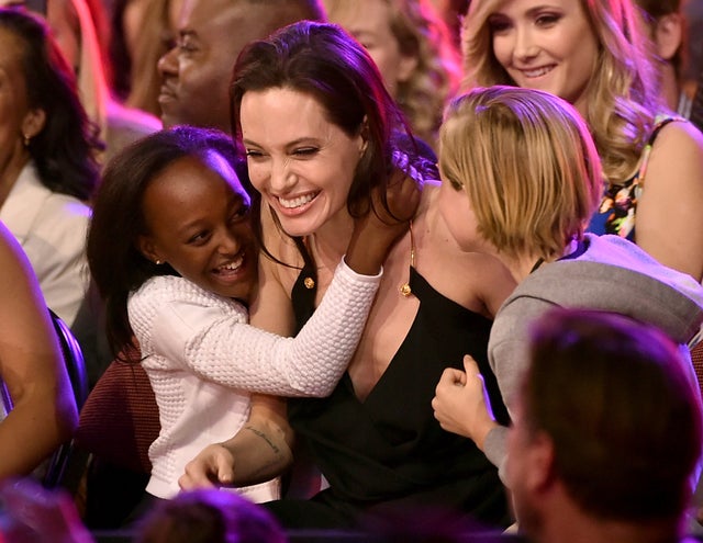 Angelina Jolie hugs Zahara Marley Jolie-Pitt and Shiloh Nouvel Jolie-Pitt after winning award for Favorite Villain in 'Maleficent' during Nickelodeon's 28th Annual Kids' Choice Awards 