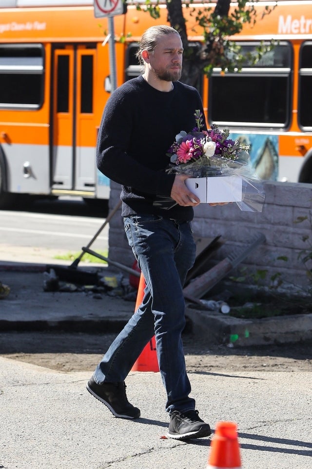 charlie hunnam carrying flowers