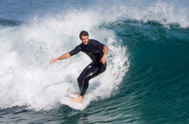 liam hemsworth surfs in australia on 3/29