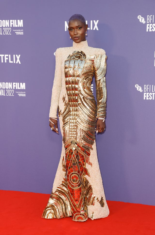 Jodie Turner-Smith attends the 66th BFI London Film Festival in a long turtle neck gold and beige dress