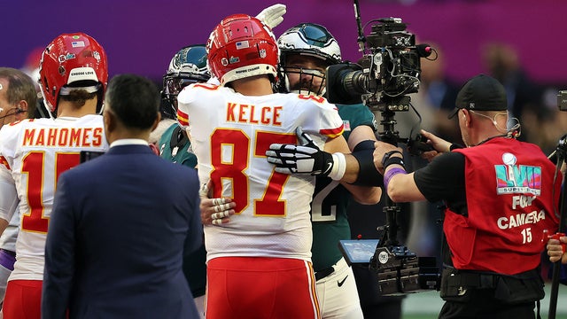 Travis and Jason Kelce Share a Big Brotherly Hug on the Super Bowl Field  Prior to Kick Off