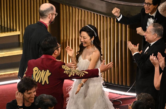Michelle Yeoh and Ke Huy Quan celebrate Daniel Kwan and Daniel Scheinert after they won the Oscar for Best Original Screenplay