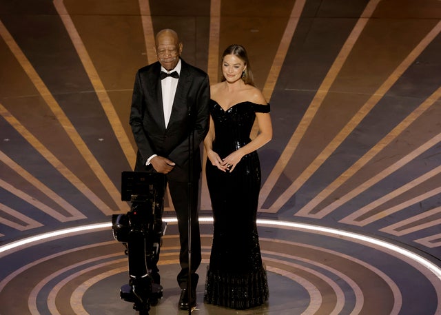 Morgan Freeman and Margot Robbie on stage at the Oscars