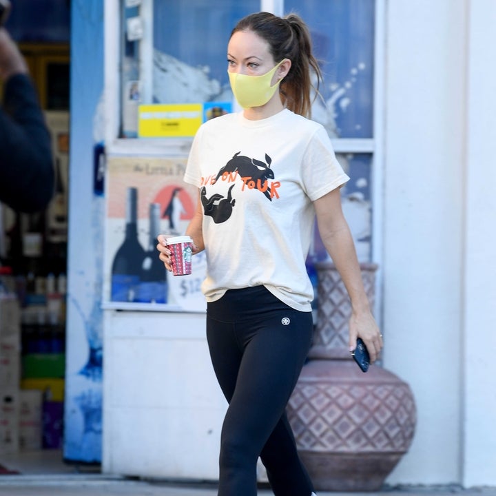 Olivia Wilde wears boyfriend Harry Styles' Love on Tour t-shirt with  black leggings during a