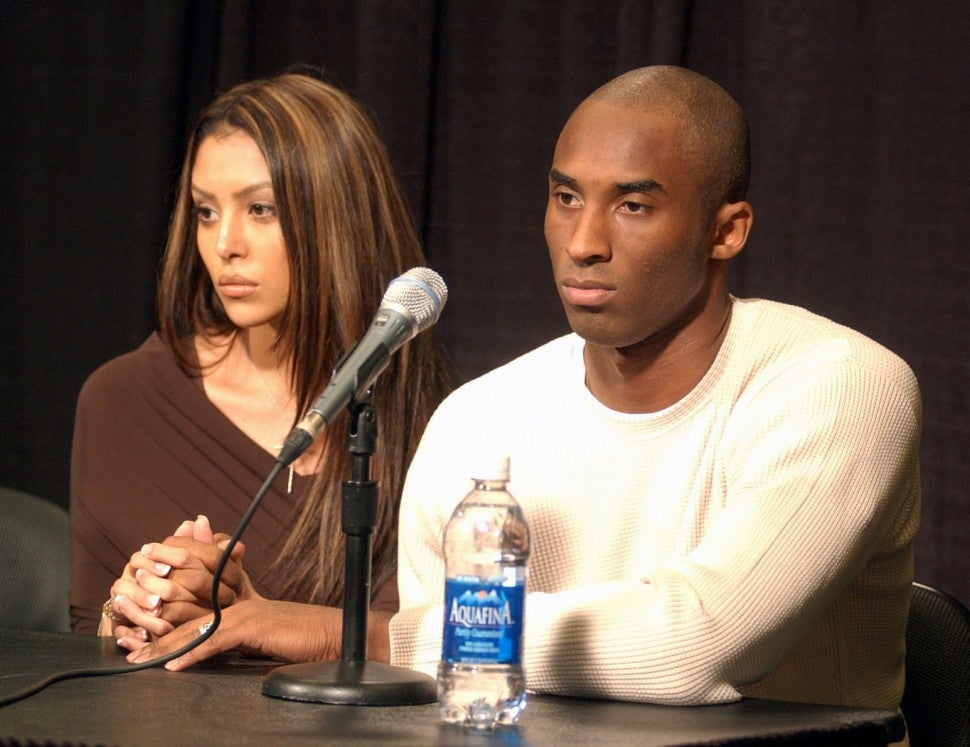 Kobe Bryant (left) with wife Vanessa at Staples Center press conference.