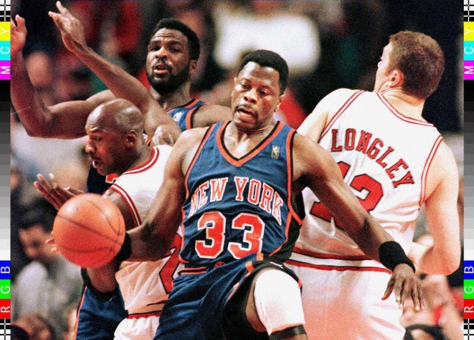 Patrick Ewing (C) holds back Chicago Bulls guard Michael Jordan (L) and Bulls Luc Longley (R) from grabbing a rebound as Knicks forward Charles Oakley (background) looks on in the first quarter 21 January at the United Center in Chicago, Illinois. 