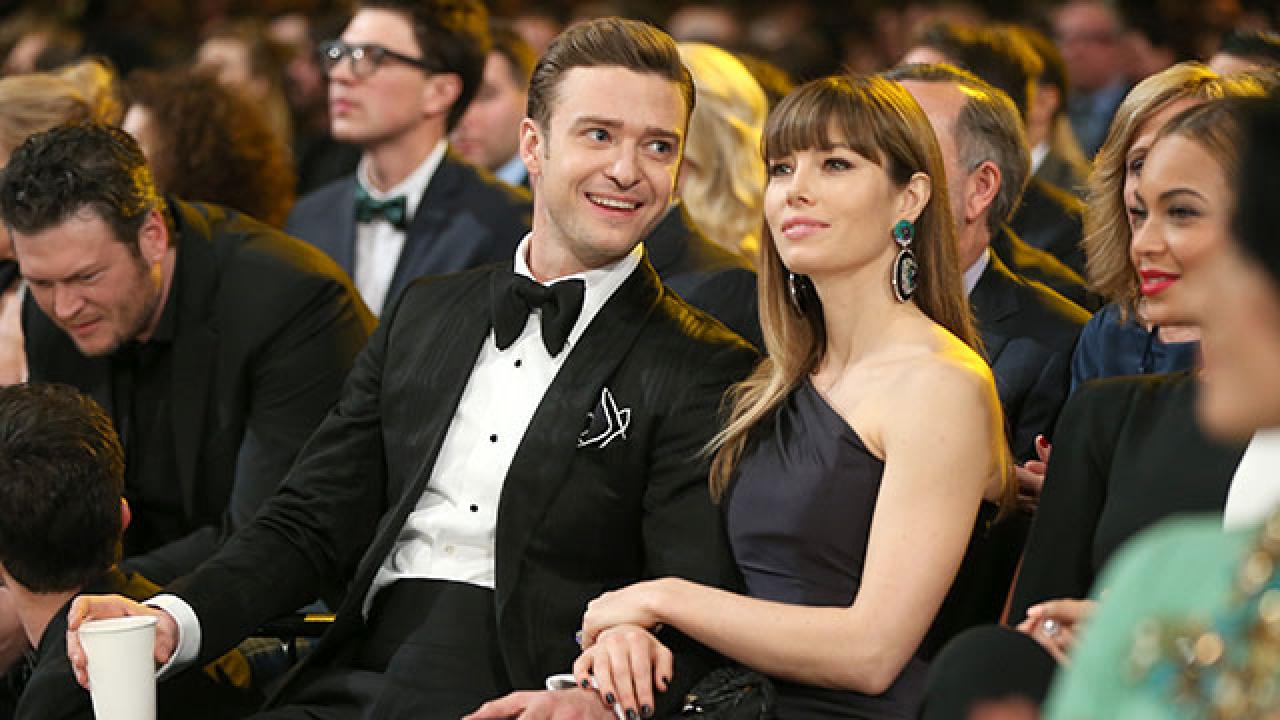 Justin Timberlake cradles son Silas as he and Jessica Biel board