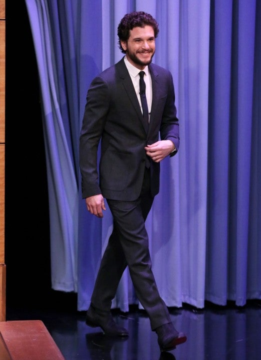 David Beckham looks dapper in a black suit and pristine white